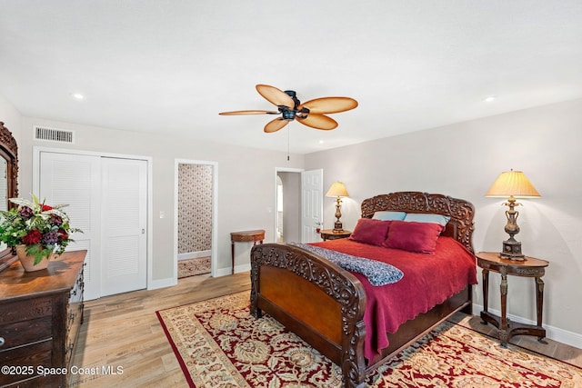 bedroom with baseboards, ceiling fan, visible vents, and light wood-style floors