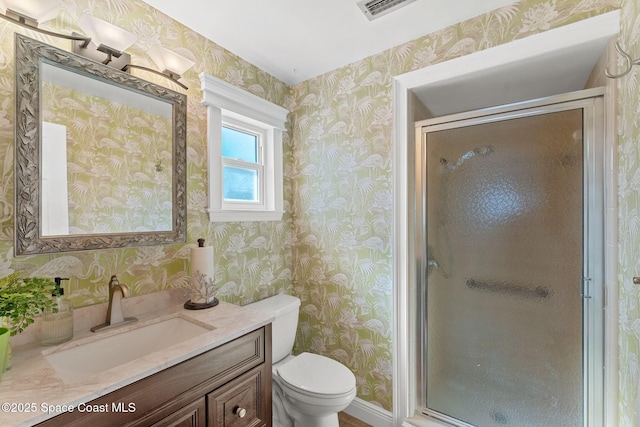 bathroom with toilet, wallpapered walls, a shower stall, and visible vents