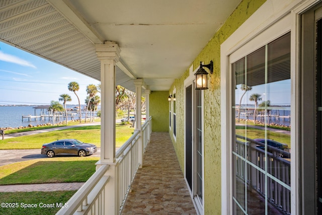 exterior space with covered porch and a water view