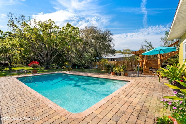 view of swimming pool with fence, a fenced in pool, and a patio