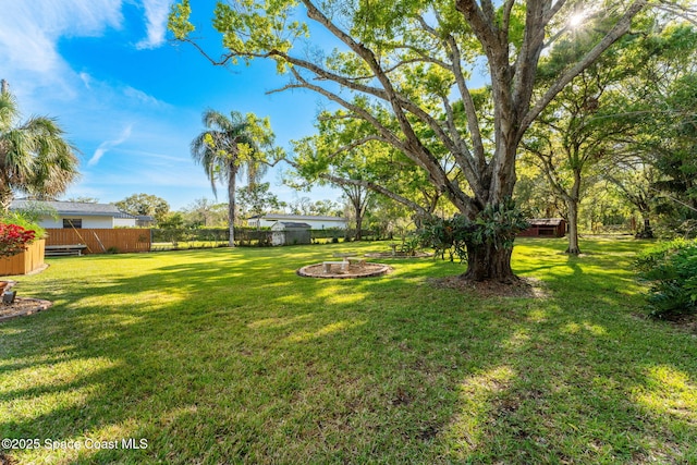 view of yard featuring fence and an outdoor structure