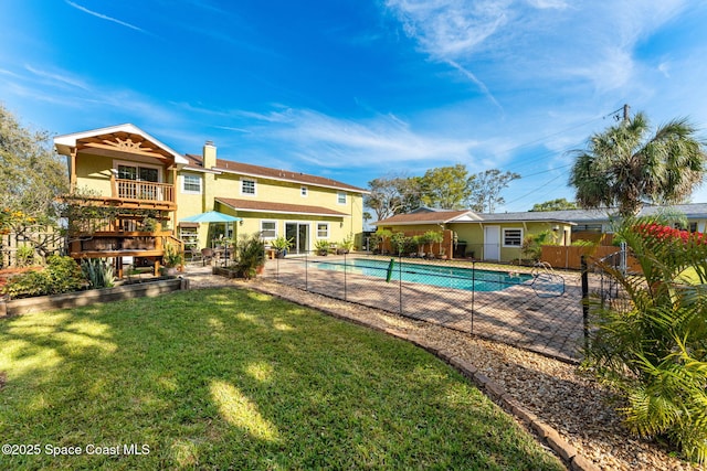 view of pool with a lawn, fence, a fenced in pool, and a patio