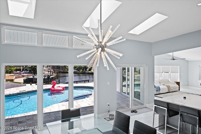 tiled bedroom featuring a water view, a skylight, access to exterior, and a notable chandelier