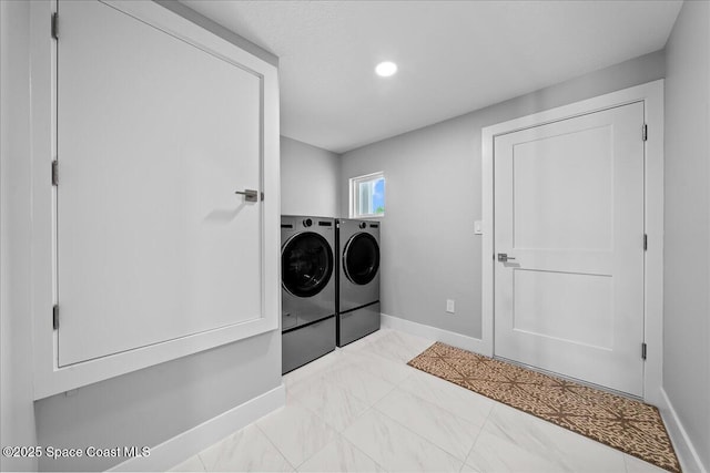 clothes washing area featuring independent washer and dryer