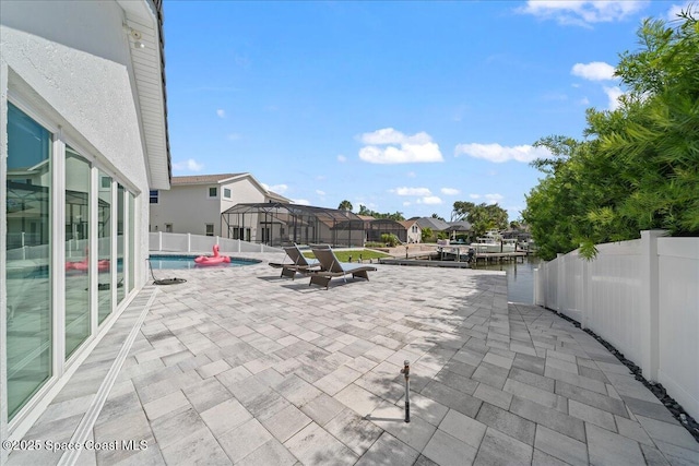 view of patio / terrace with a fenced in pool and glass enclosure