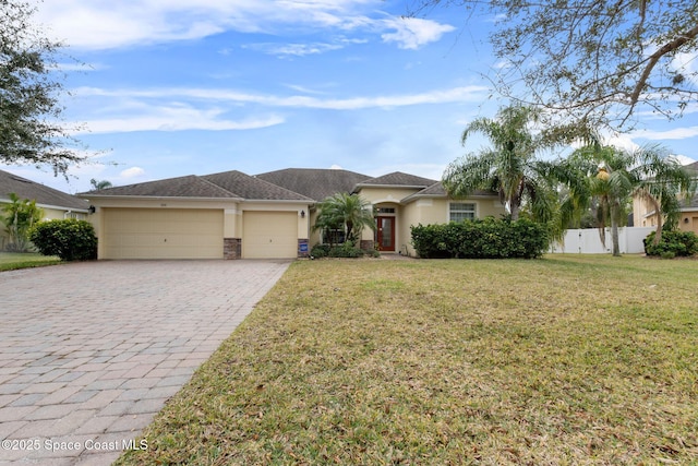 view of front of home featuring a front yard and a garage