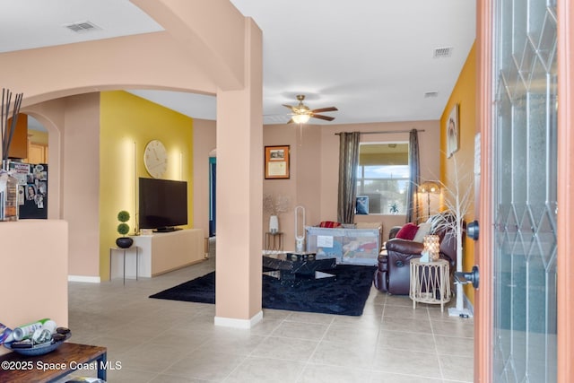 tiled entryway featuring ceiling fan