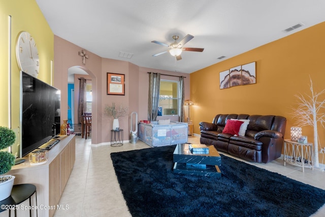 tiled living room with ceiling fan