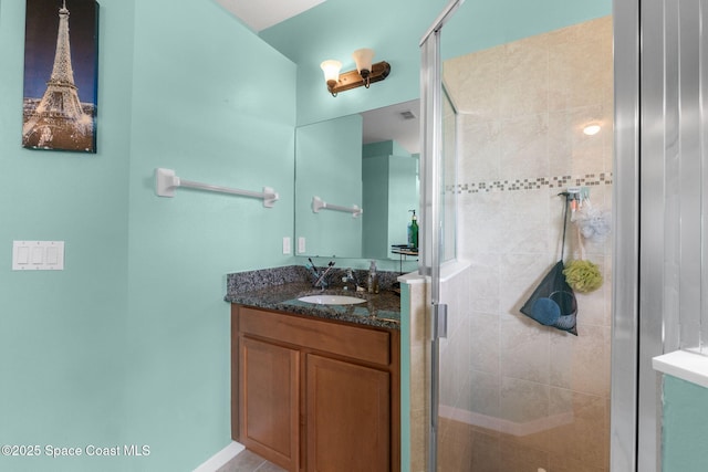 bathroom featuring vanity and a shower with shower door