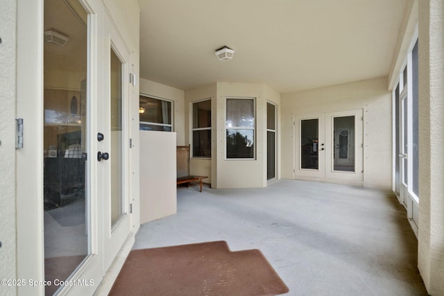 unfurnished sunroom featuring french doors