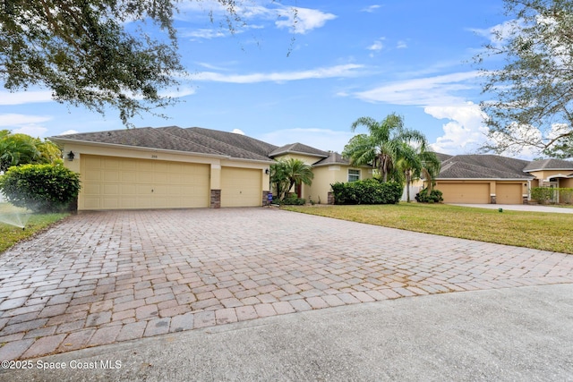 single story home featuring a front yard and a garage