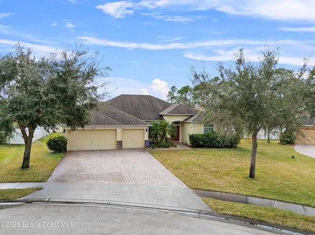 view of front of property with a garage and a front lawn