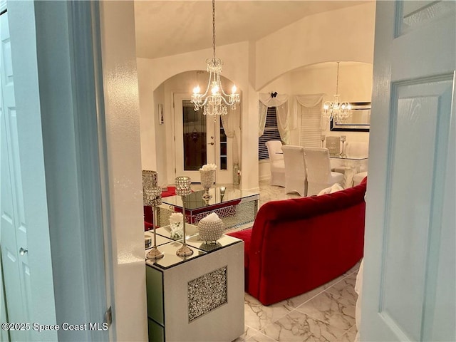 bathroom with lofted ceiling and a chandelier