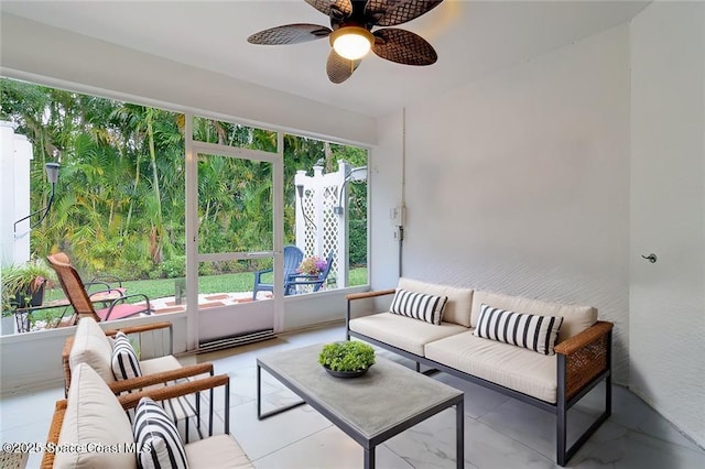 sunroom featuring ceiling fan