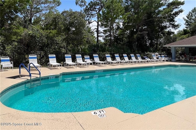 community pool with a patio area