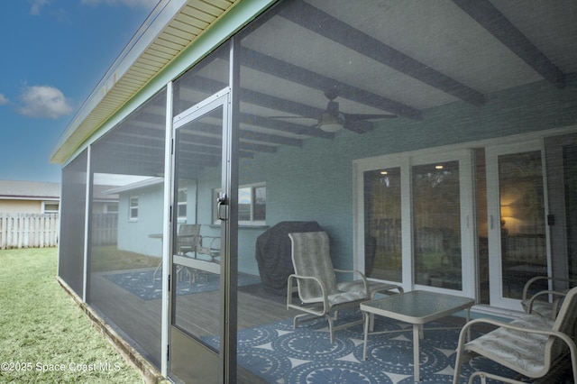 wooden terrace featuring ceiling fan and a sunroom