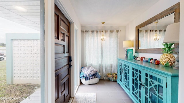 interior space featuring tile patterned floors and a chandelier