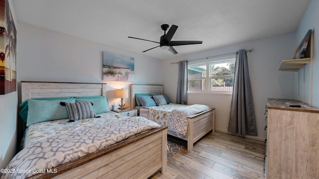 bedroom featuring light wood-type flooring and ceiling fan