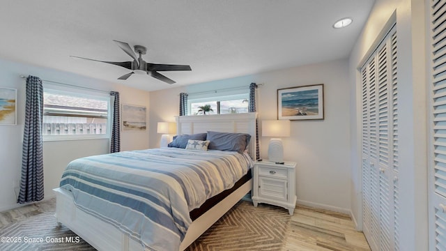 bedroom featuring ceiling fan, a closet, and light hardwood / wood-style flooring