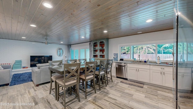 dining area featuring wooden ceiling, sink, ceiling fan, and light wood-type flooring