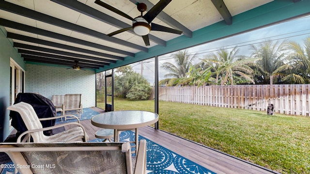 sunroom / solarium with ceiling fan and beam ceiling