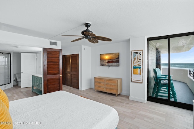 bedroom with a closet, ceiling fan, a textured ceiling, light hardwood / wood-style flooring, and access to outside