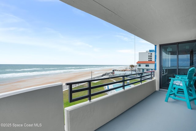 balcony with a view of the beach and a water view