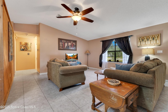 tiled living room with lofted ceiling, ceiling fan, and a textured ceiling