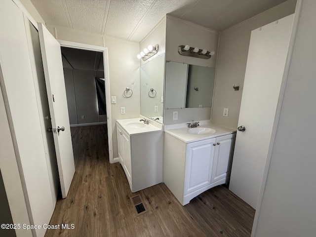 bathroom featuring vanity, a textured ceiling, and hardwood / wood-style floors