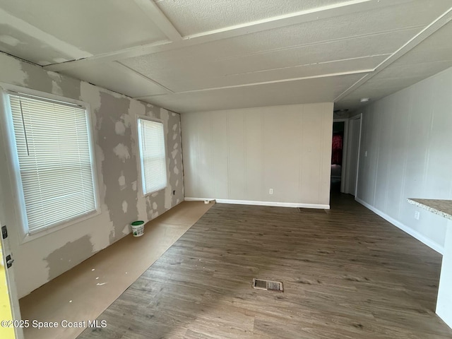 unfurnished room with dark hardwood / wood-style flooring