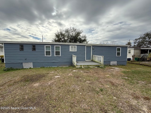 rear view of house featuring a lawn