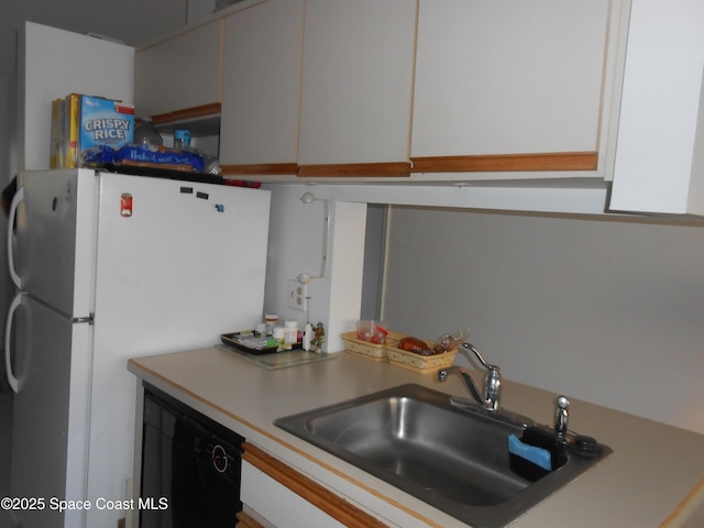 kitchen with white cabinets, dishwasher, sink, and white fridge