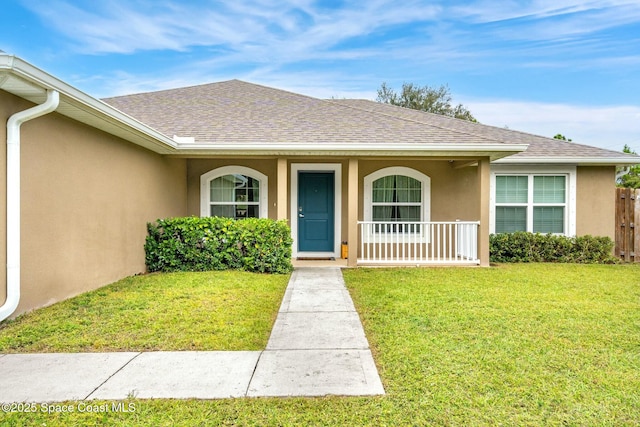 doorway to property with a yard