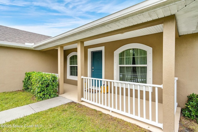 view of exterior entry with covered porch