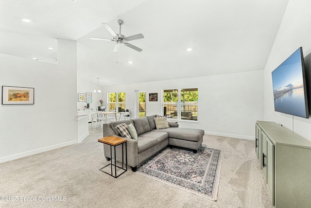 living room featuring high vaulted ceiling, light colored carpet, and ceiling fan