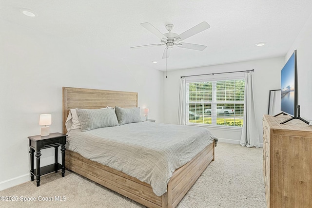 bedroom with light carpet and ceiling fan