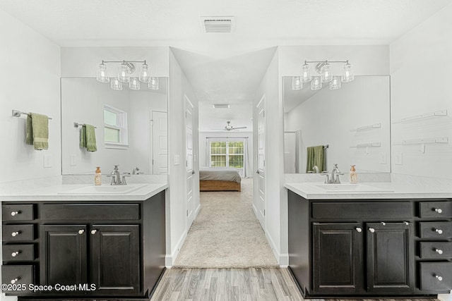 bathroom featuring ceiling fan, wood-type flooring, and vanity