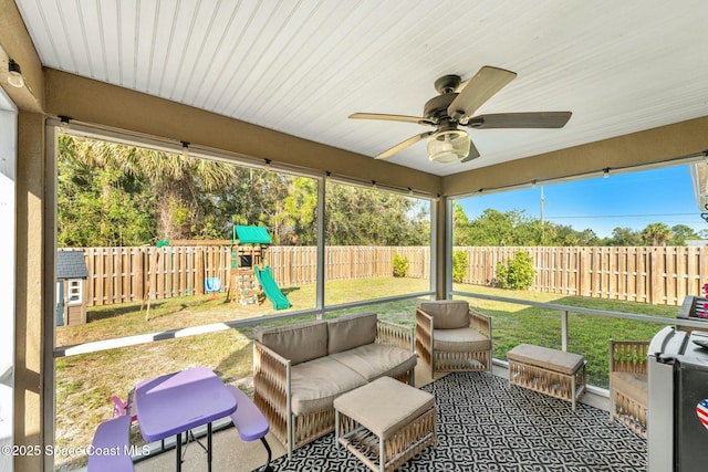 sunroom / solarium featuring ceiling fan