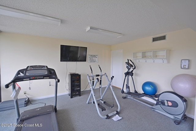 300 Columbia Dr Unit 5051, Cape Canaveral, FL 32920 - workout room featuring a textured ceiling