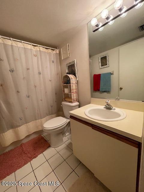 300 Columbia Dr Unit 5051, Cape Canaveral, FL 32920 - bathroom featuring tile patterned flooring, vanity, walk in shower, and toilet