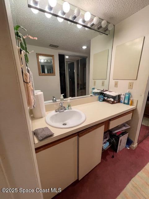 300 Columbia Dr Unit 5051, Cape Canaveral, FL 32920 - bathroom featuring vanity and a textured ceiling