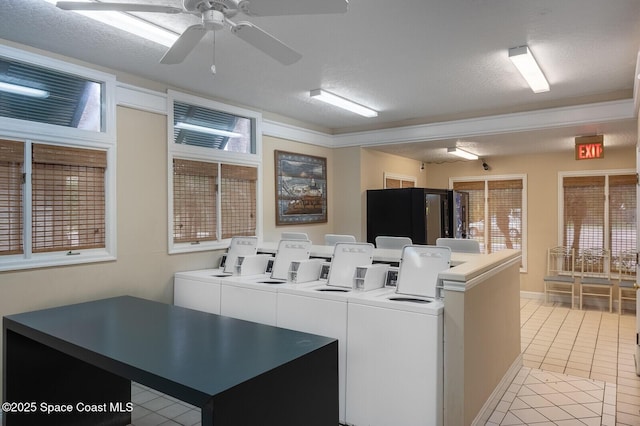 laundry room with ceiling fan, a textured ceiling, light tile patterned floors, and washing machine and clothes dryer