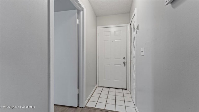 hall featuring light tile patterned flooring