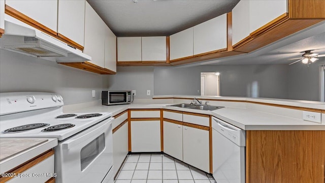 kitchen with white cabinets, kitchen peninsula, sink, and white appliances