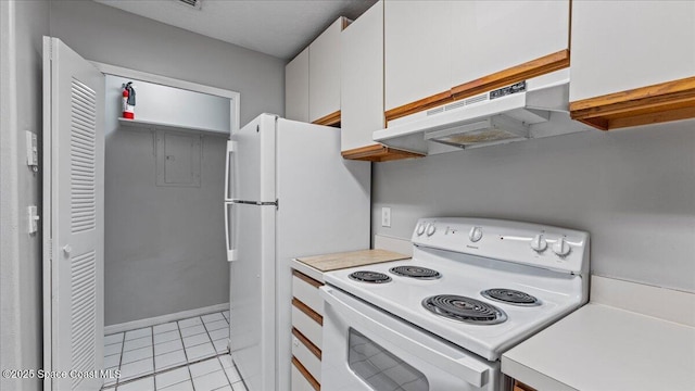 kitchen featuring electric stove, white cabinetry, and light tile patterned flooring