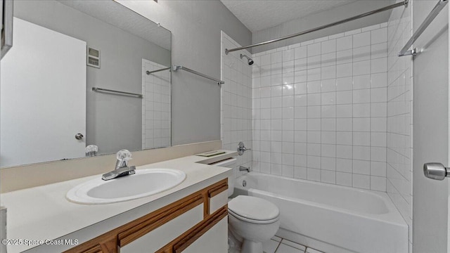 full bathroom with toilet, tiled shower / bath combo, tile patterned flooring, a textured ceiling, and vanity