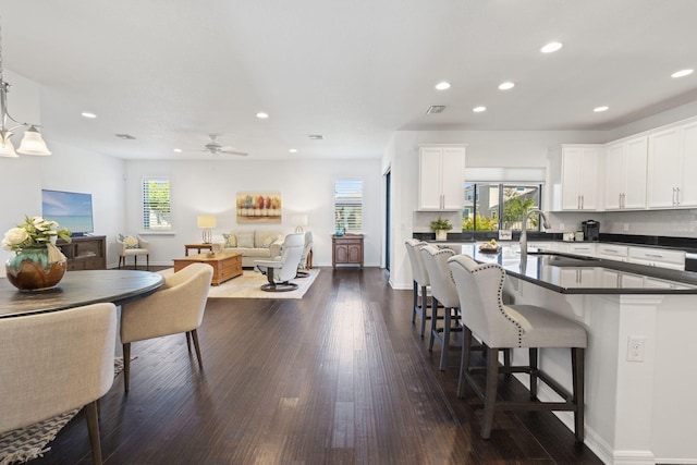 kitchen featuring sink, ceiling fan, white cabinetry, and dark hardwood / wood-style floors