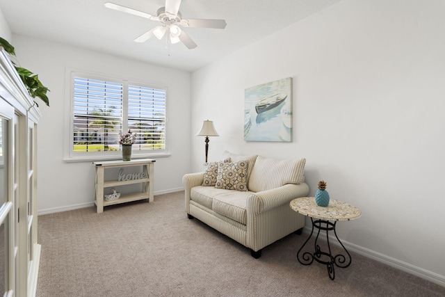 sitting room with ceiling fan and light colored carpet