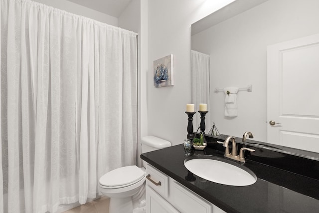 bathroom with toilet, tile patterned floors, and vanity