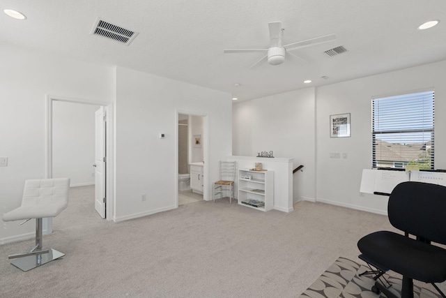 home office with light carpet and ceiling fan